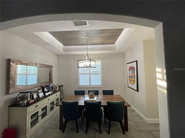 a dining room with furniture and window