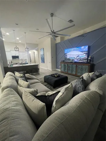 a living room with furniture and a chandelier