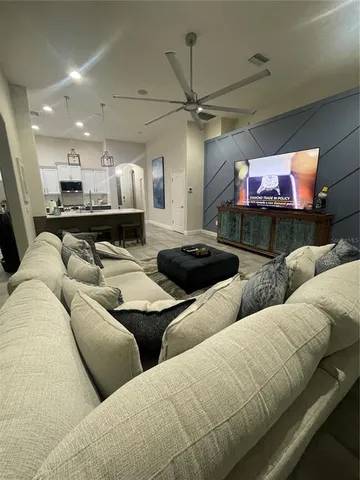 a living room with furniture and a chandelier
