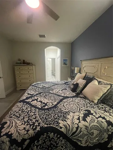 a bedroom with a bed and a mirror