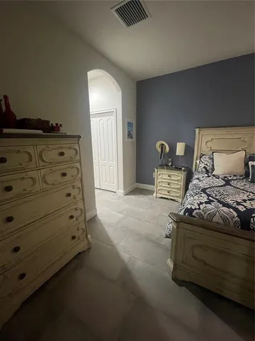 a bed sitting in a bedroom next to a window
