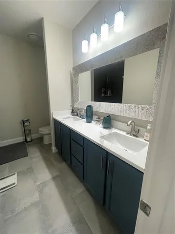 a bathroom with a double vanity sink and a mirror