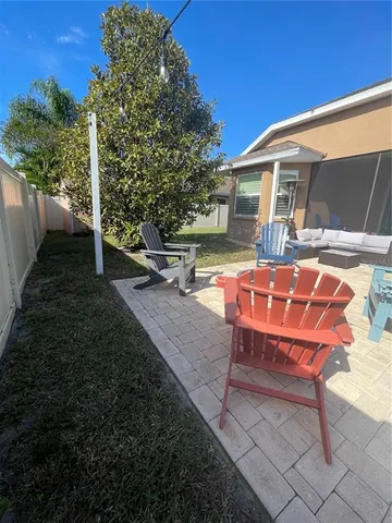 a backyard of a house with table and chairs