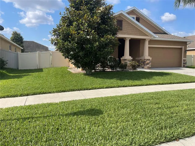 a front view of house with yard and green space