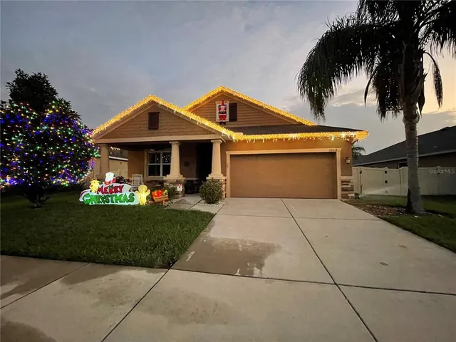 a front view of a house with a garden and trees