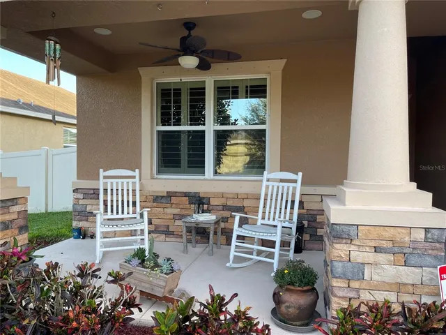 a balcony with furniture and flowers