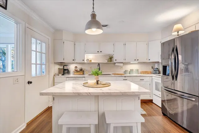 a bathroom with a sink a toilet a mirror and shower
