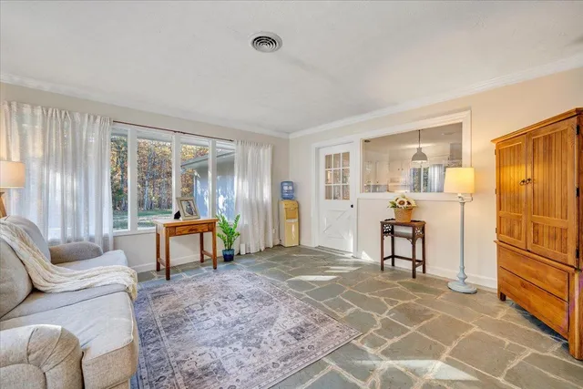 a front view of a house with a garden and trees