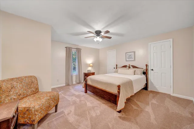 a front view of a house with a garden and yard