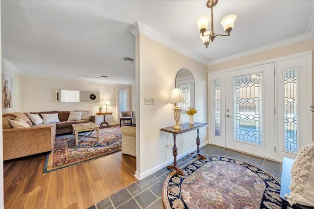a view of a dining room with furniture and a chandelier