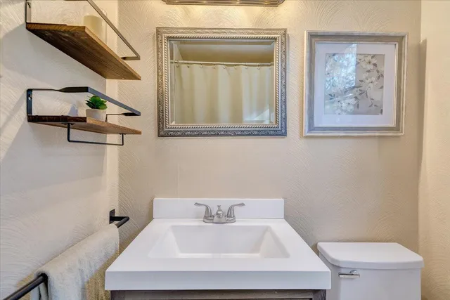 a view of a pathway with a wrought fence