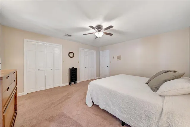 an aerial view of a house with a yard and lake view