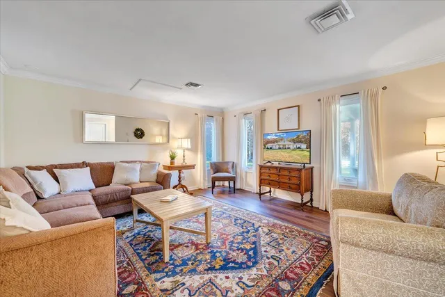 a living room with furniture large window and flat screen tv