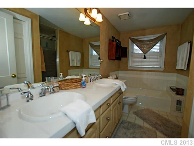 1943 Harris Road Charlotte, NC 28211 - Photo 11 of 16 a bathroom with a sink vanity and mirror