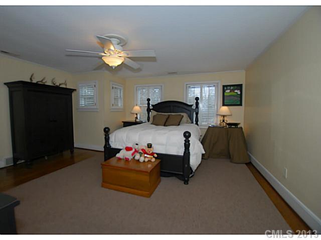 1943 Harris Road Charlotte, NC 28211 - Photo 12 of 16 a bedroom with a bed and a chandelier