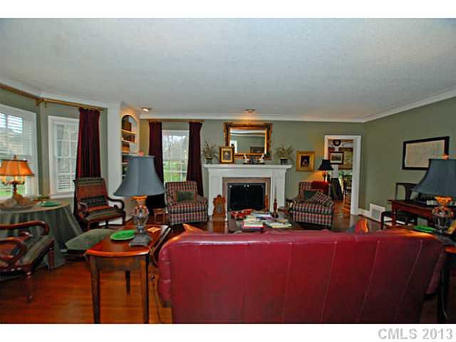 1943 Harris Road Charlotte, NC 28211 - Photo 3 of 16 a living room with furniture a fireplace and a flat screen tv