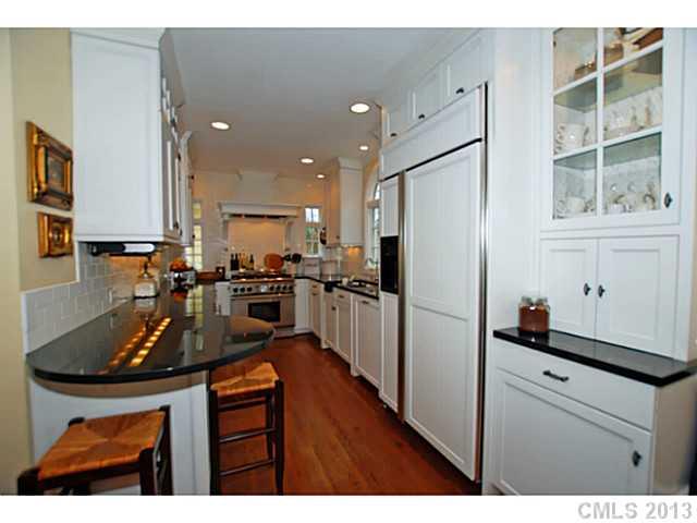 1943 Harris Road Charlotte, NC 28211 - Photo 5 of 16 a kitchen with kitchen island a counter top space a sink stainless steel appliances and cabinets
