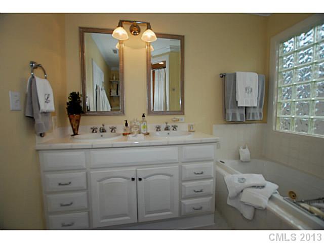 1943 Harris Road Charlotte, NC 28211 - Photo 8 of 16 a bathroom with a sink vanity and a mirror