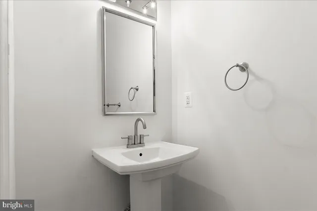 a bathroom with a sink and mirror