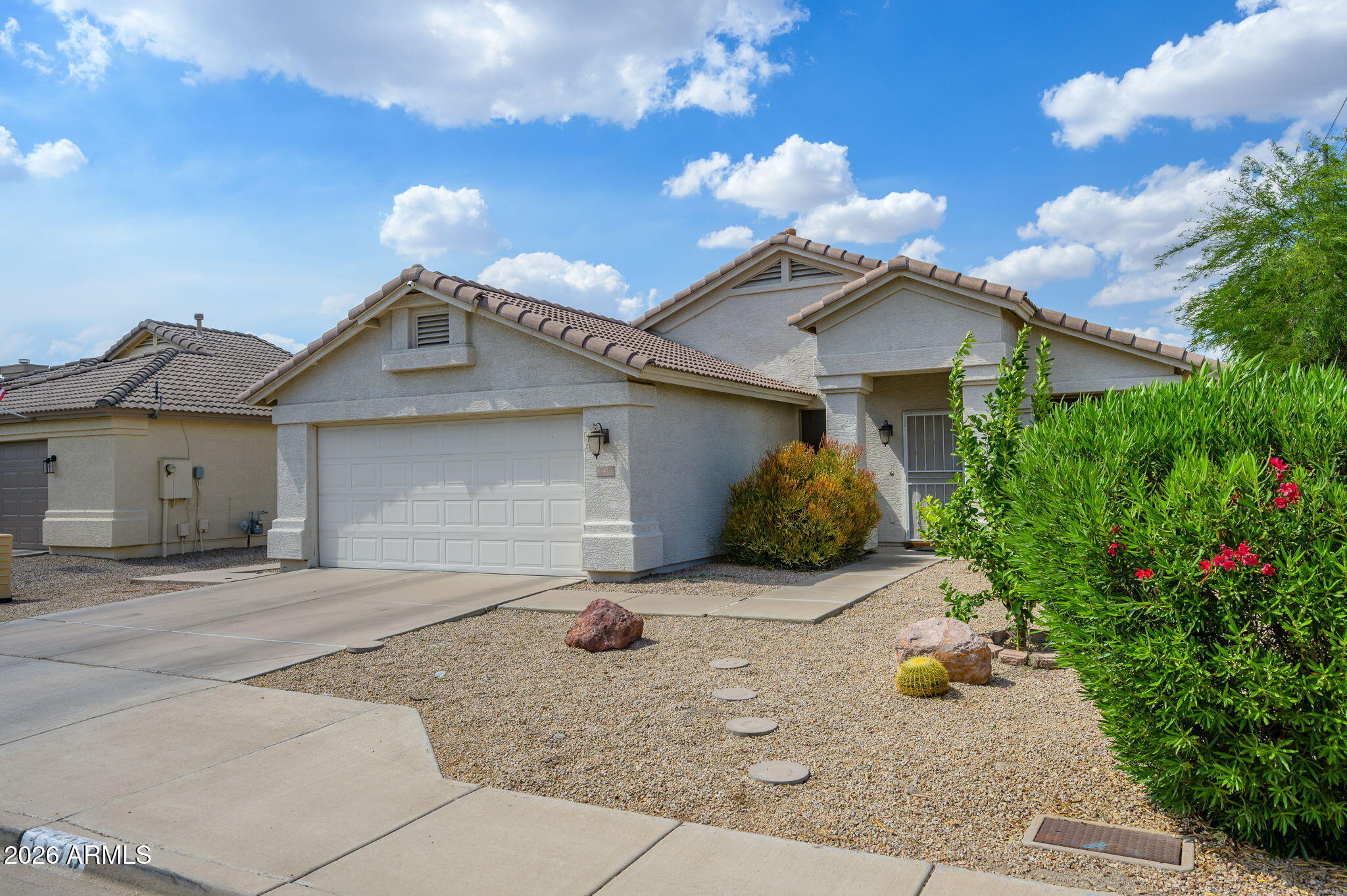 3136 East Roveen Avenue Phoenix, AZ 85032 - Photo 36 of 38 a front view of a house with a garden and a tree