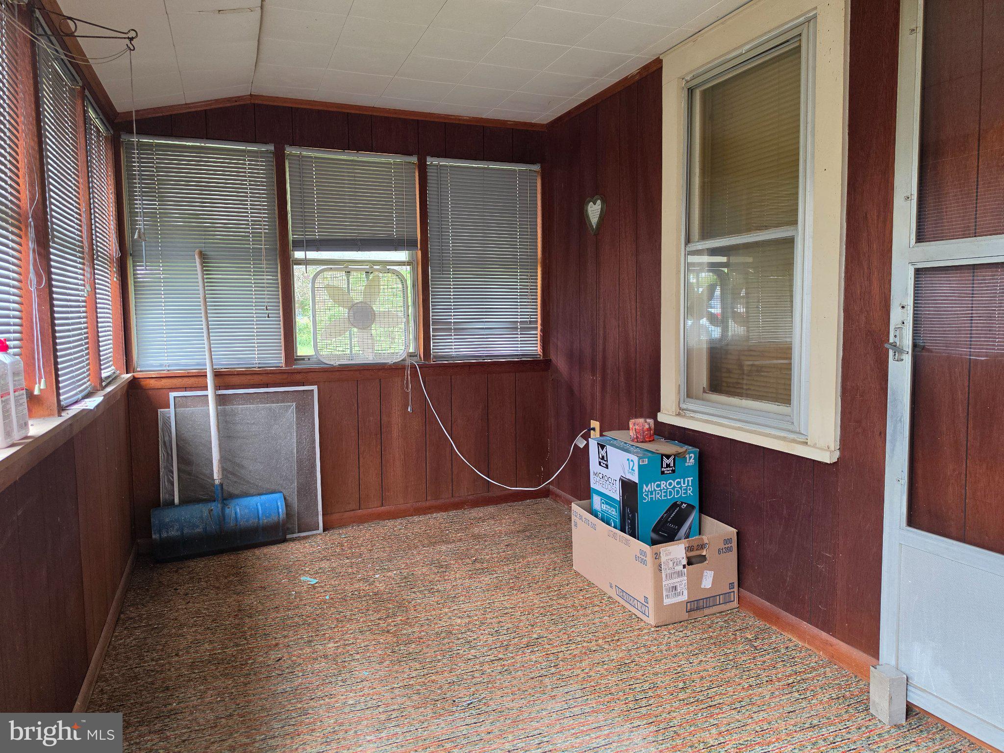 210 Groff Road Millington, MD 21651 - Photo 5 of 14 Charming sunlit porch with rustic appeal.