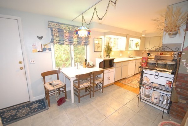 5 Coderre Way Andover, MA 01810 - Photo 6 of 29 a view of a dining room with furniture a chandelier and wooden floor