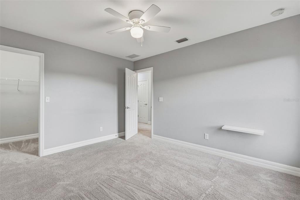 25134 Palisade Road Punta Gorda, FL 33983 - Photo 40 of 58 an empty room with a ceiling fan and a fan
