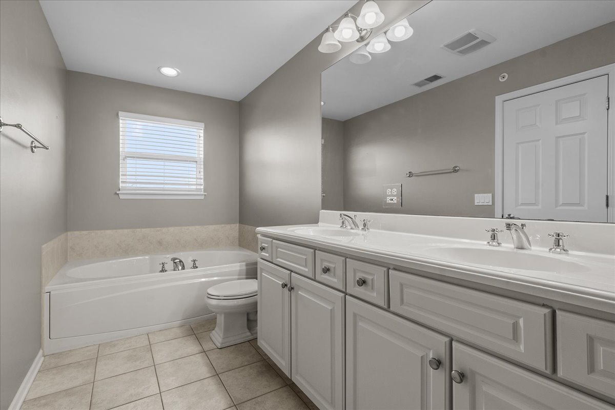 705 Lyster Road Highwood, IL 60040 - Photo 13 of 24 a spacious bathroom with a double vanity sink a toilet a shower and a mirror
