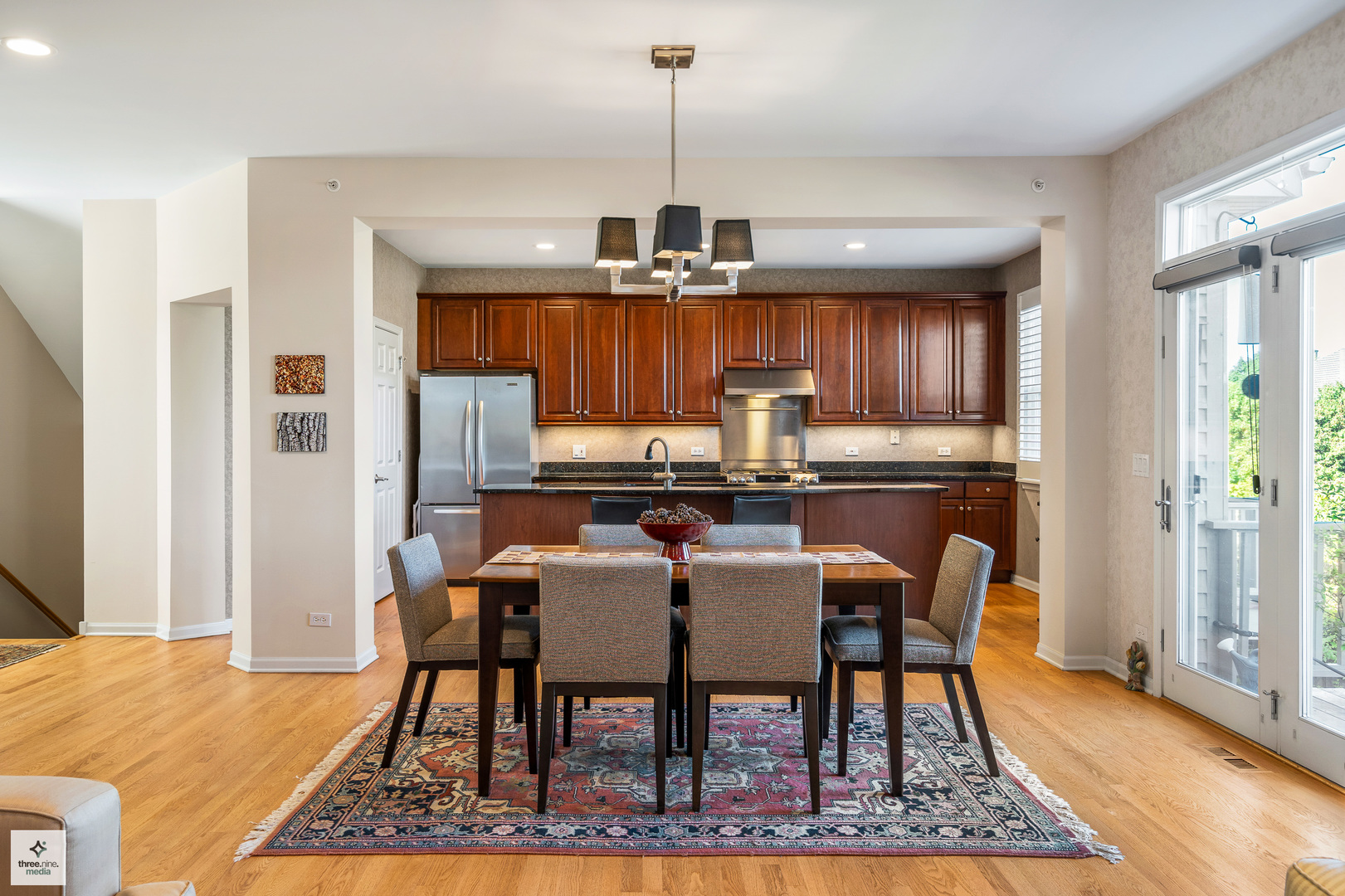 705 Lyster Road Highwood, IL 60040 - Photo 3 of 24 a dining room with furniture a rug a rug and a chandelier