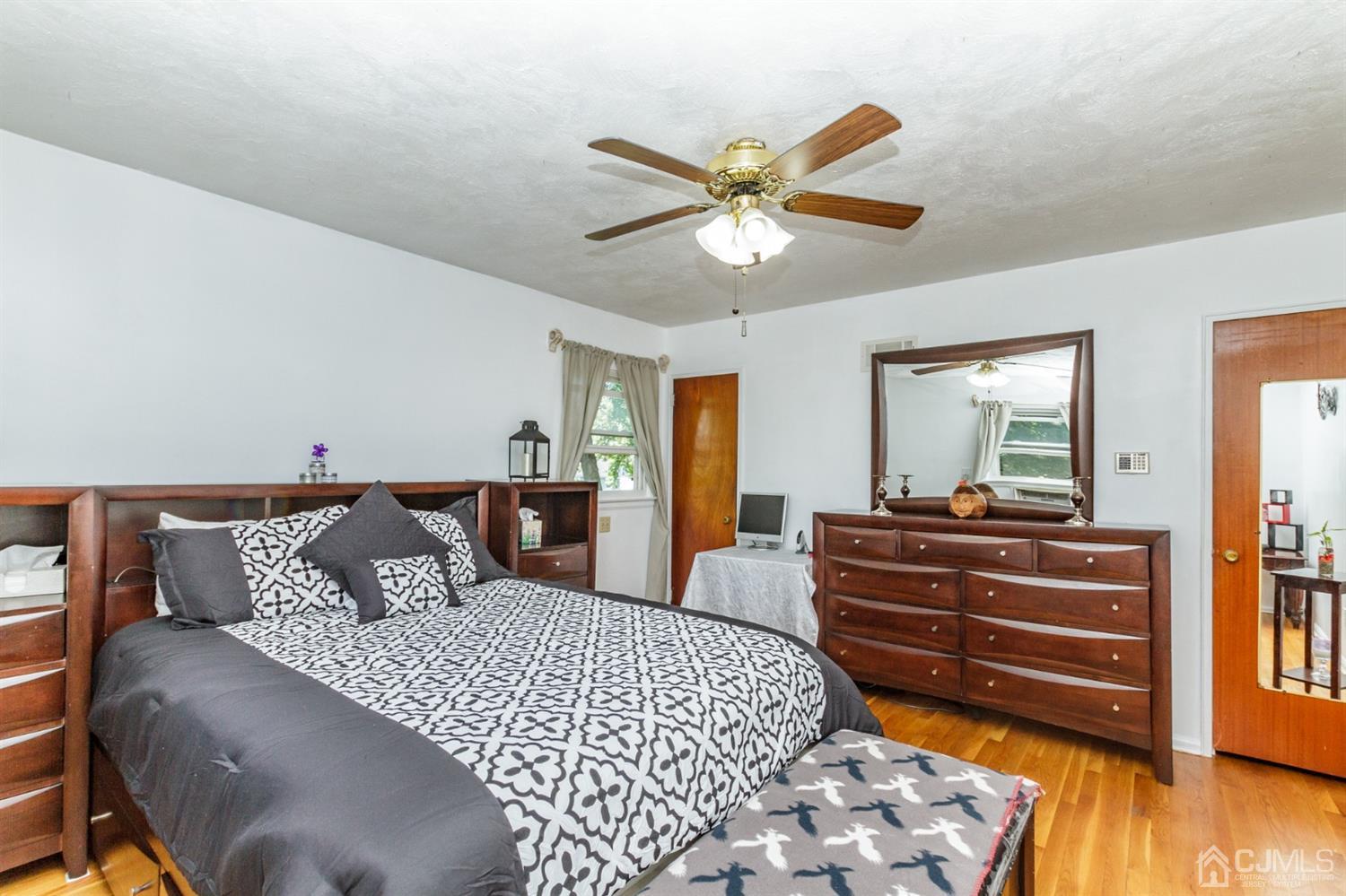 709 Exeter Road Linden, NJ 07036 - Photo 14 of 28 a bedroom with a bed and wooden floor