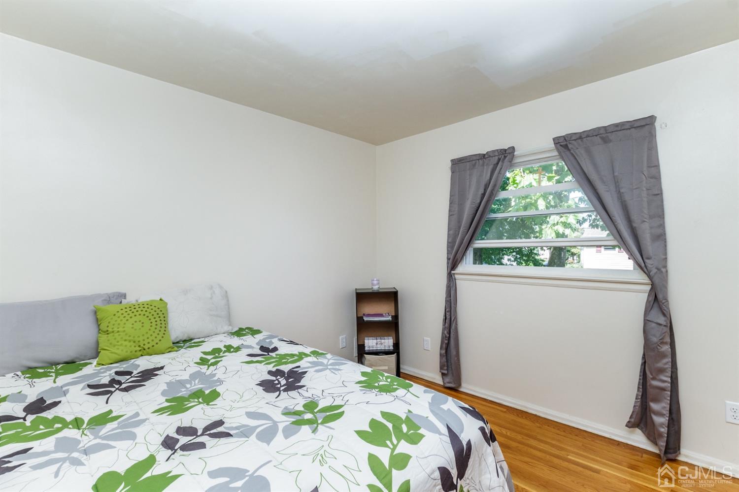 709 Exeter Road Linden, NJ 07036 - Photo 17 of 28 a bedroom with a bed and a window
