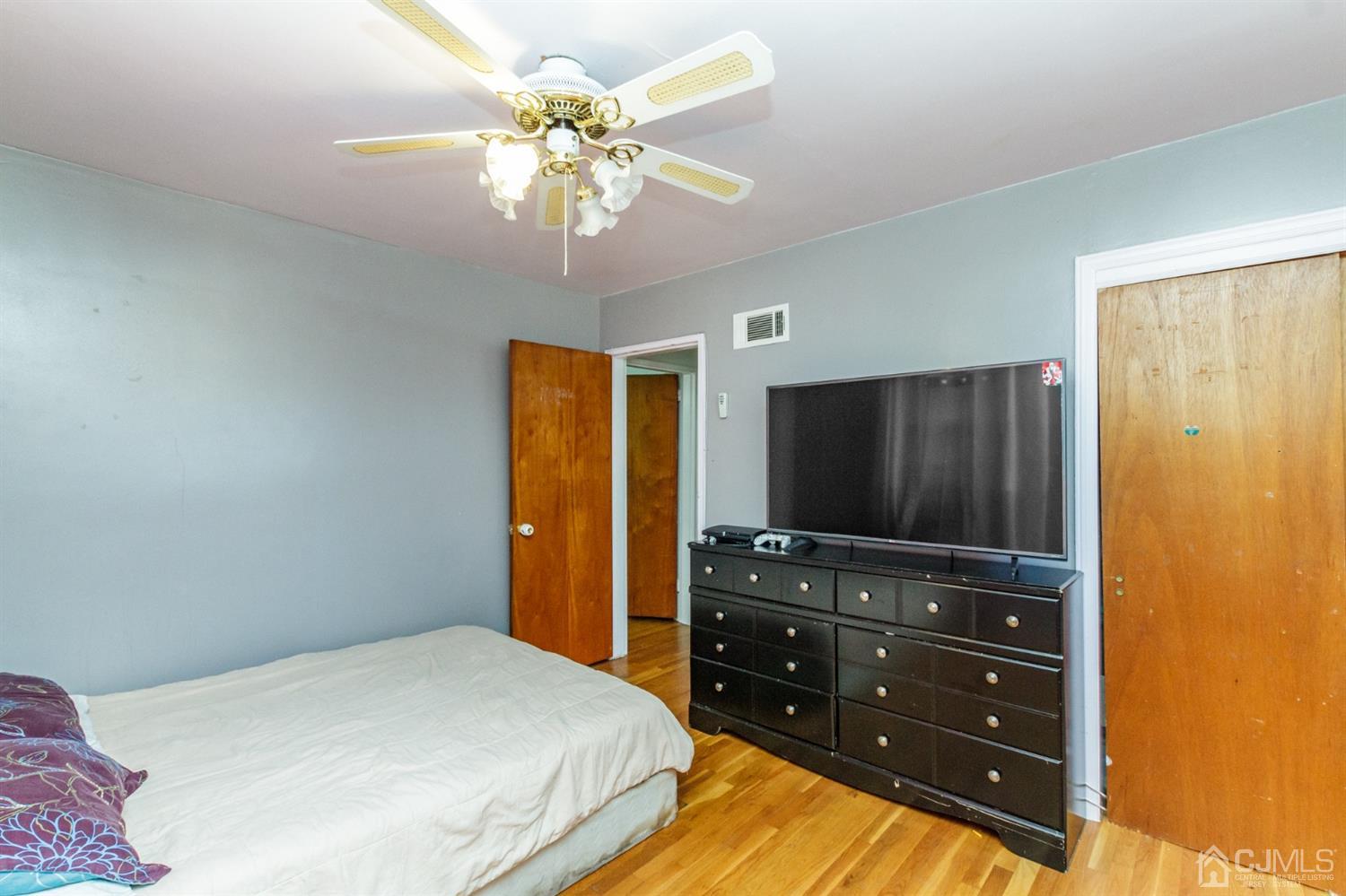 709 Exeter Road Linden, NJ 07036 - Photo 20 of 28 a bedroom with a bed and a flat screen tv