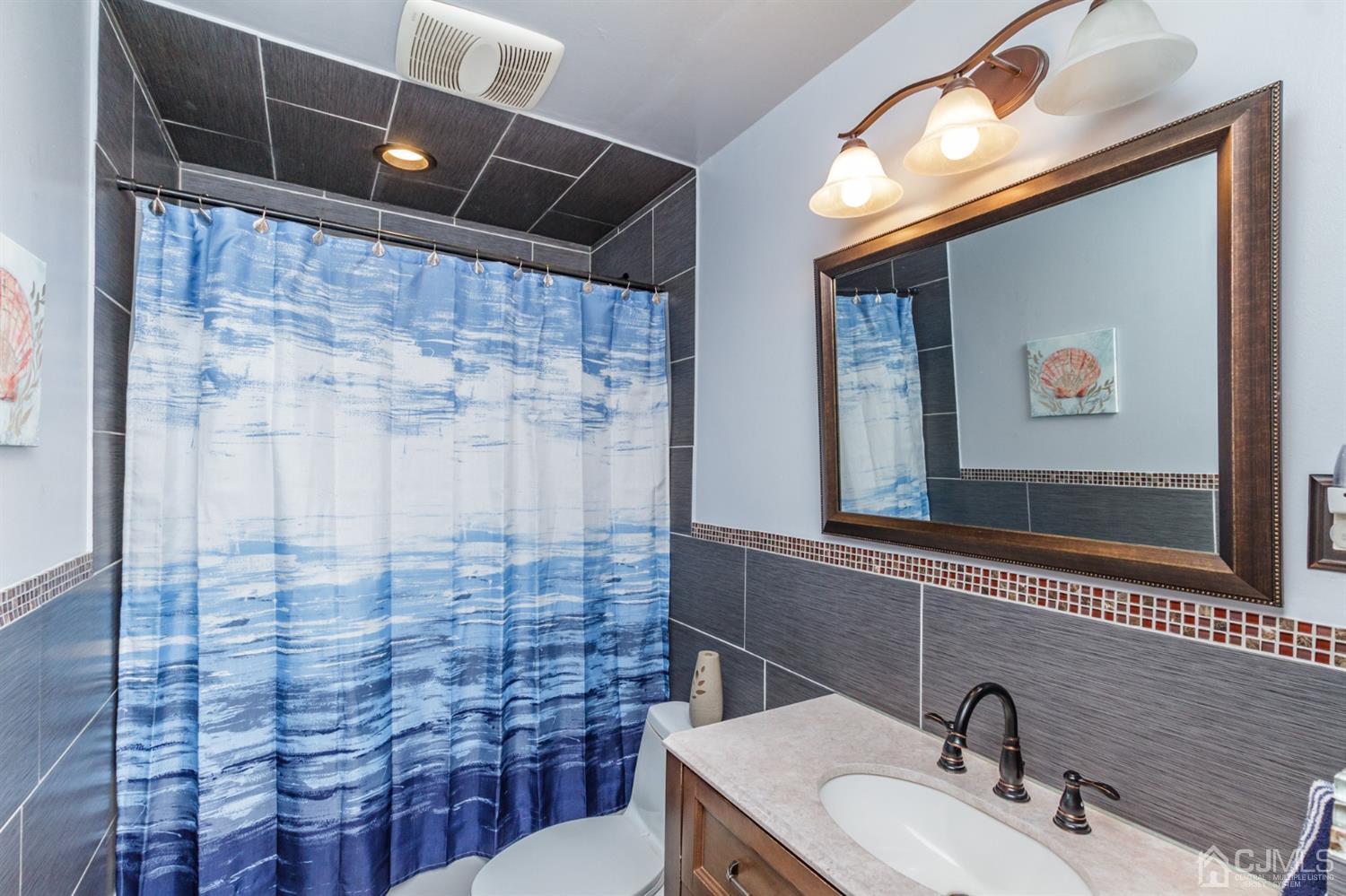 709 Exeter Road Linden, NJ 07036 - Photo 21 of 28 a bathroom with a sink and a mirror