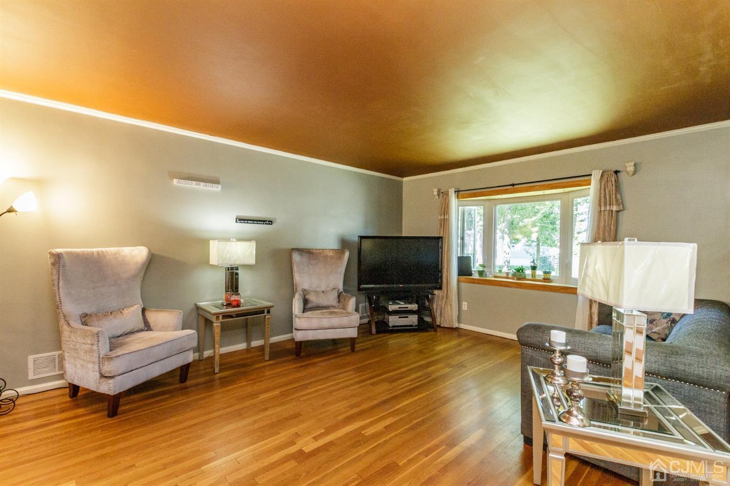 709 Exeter Road Linden, NJ 07036 - Photo 4 of 28 a living room with furniture a window and a flat screen tv
