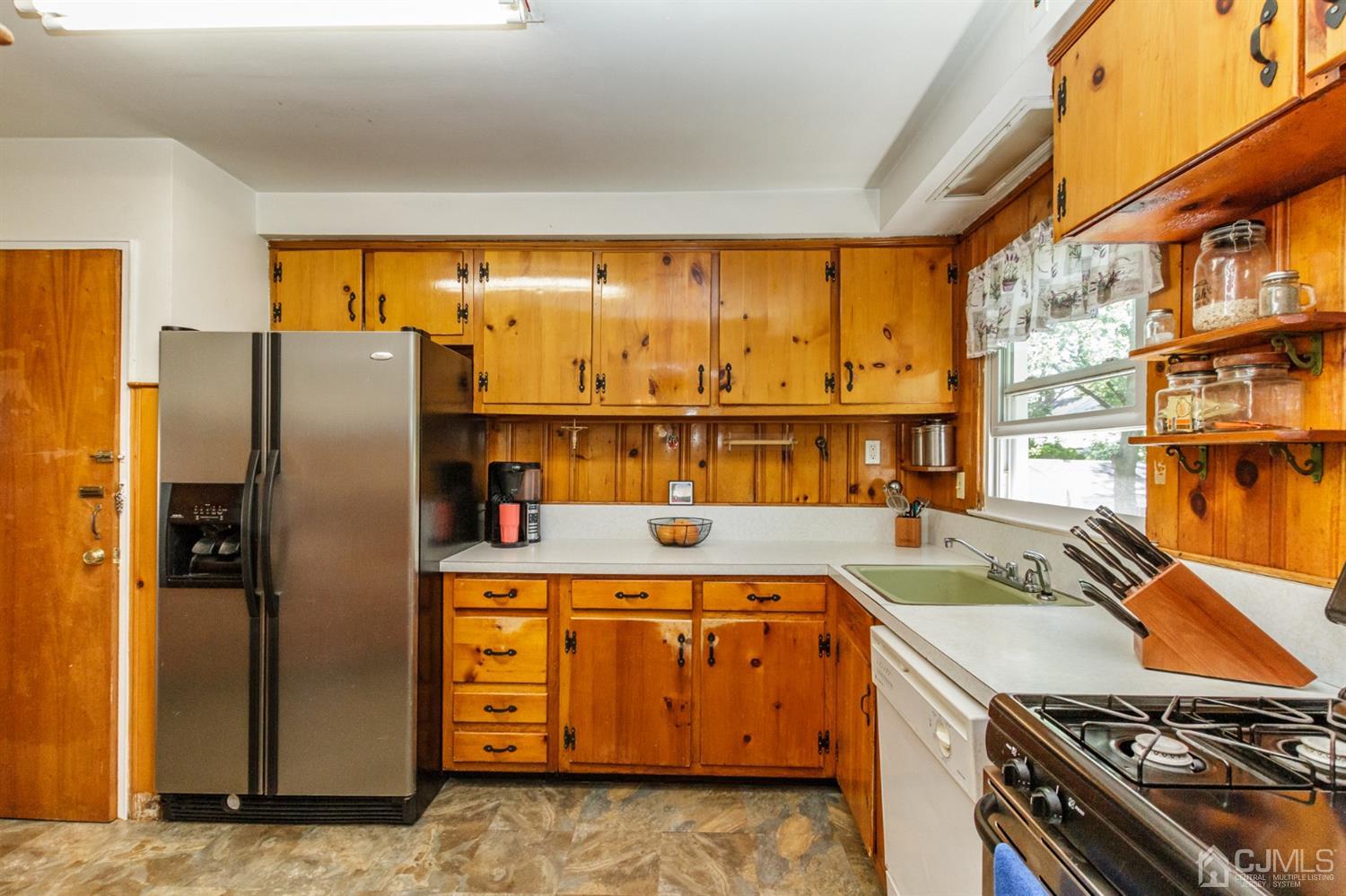 709 Exeter Road Linden, NJ 07036 - Photo 10 of 28 a kitchen with stainless steel appliances granite countertop a refrigerator a stove and a sink with cabinets