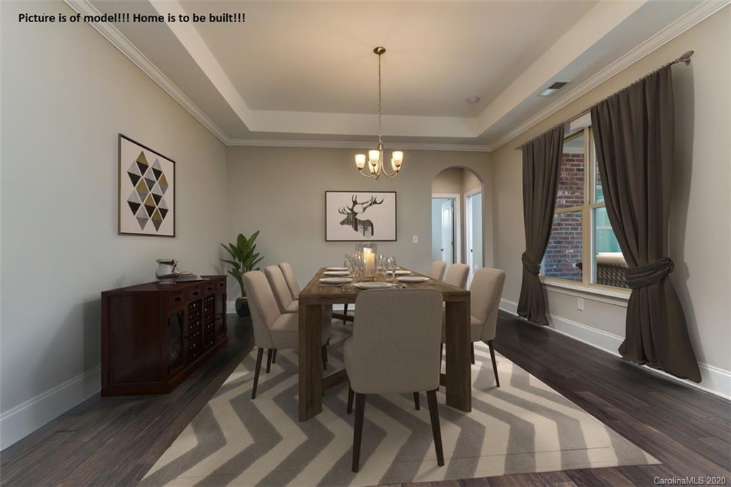 2061 New Style Way, Unit 30 Tega Cay, SC 29708 - Photo 1 of 40 a view of a dining room with furniture window and wooden floor