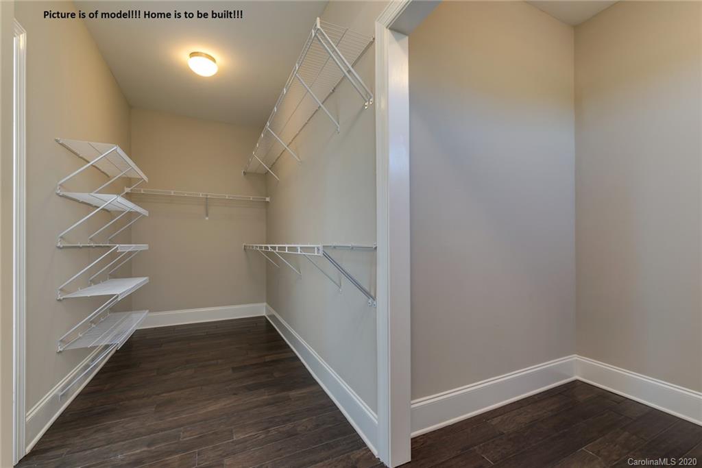2061 New Style Way, Unit 30 Tega Cay, SC 29708 - Photo 12 of 40 a view of walk in closet with empty racks