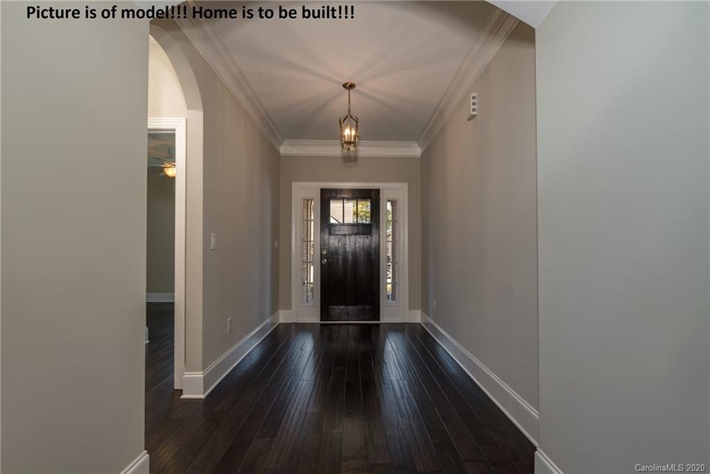 2061 New Style Way, Unit 30 Tega Cay, SC 29708 - Photo 20 of 40 a view of a hallway view with wooden floor and staircase