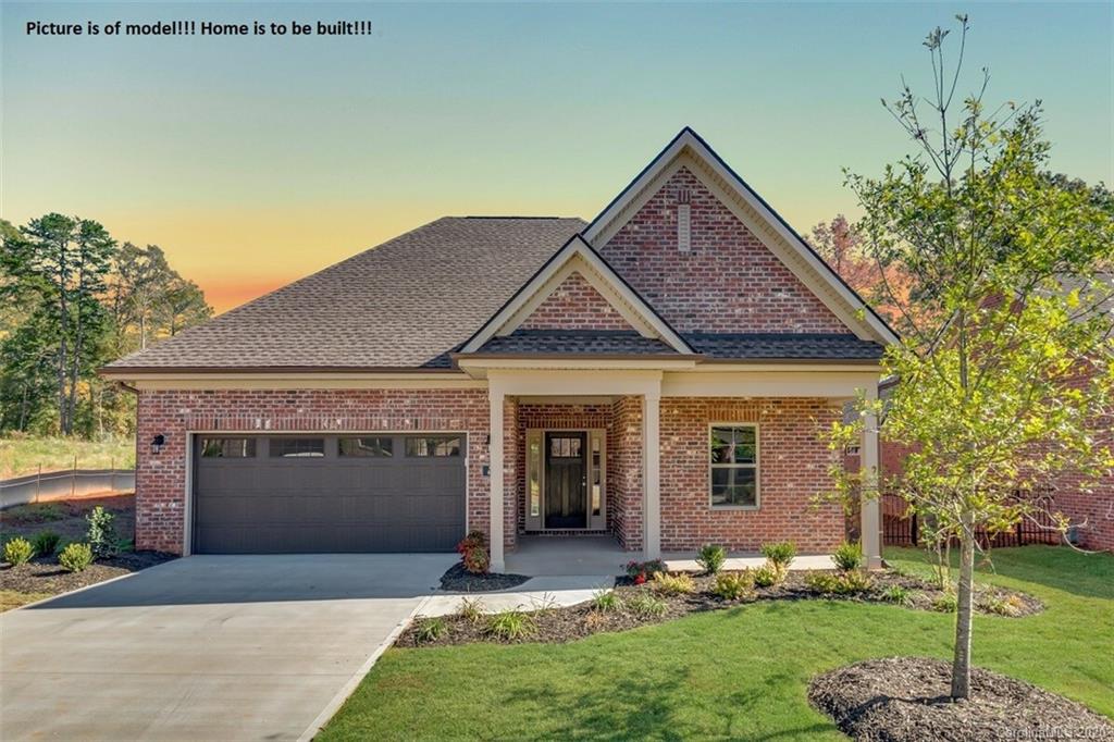 2061 New Style Way, Unit 30 Tega Cay, SC 29708 - Photo 3 of 40 a front view of a house with a yard and garage