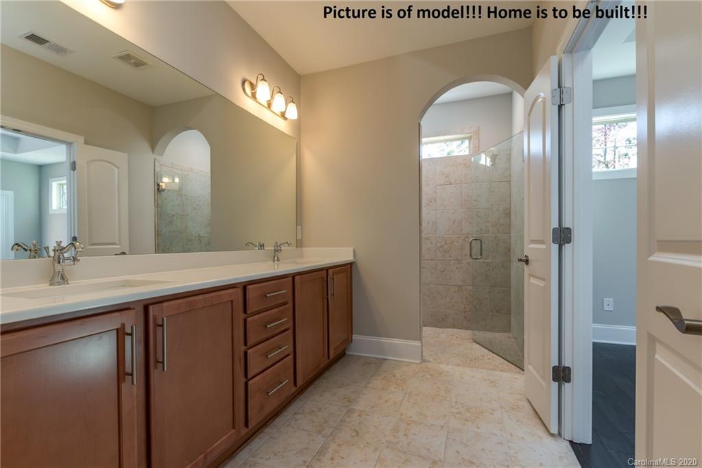 2061 New Style Way, Unit 30 Tega Cay, SC 29708 - Photo 30 of 40 a bathroom with a double vanity sink and a mirror