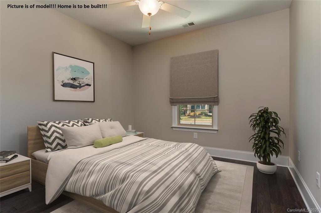 2061 New Style Way, Unit 30 Tega Cay, SC 29708 - Photo 7 of 40 a bedroom with a large bed and a potted plant