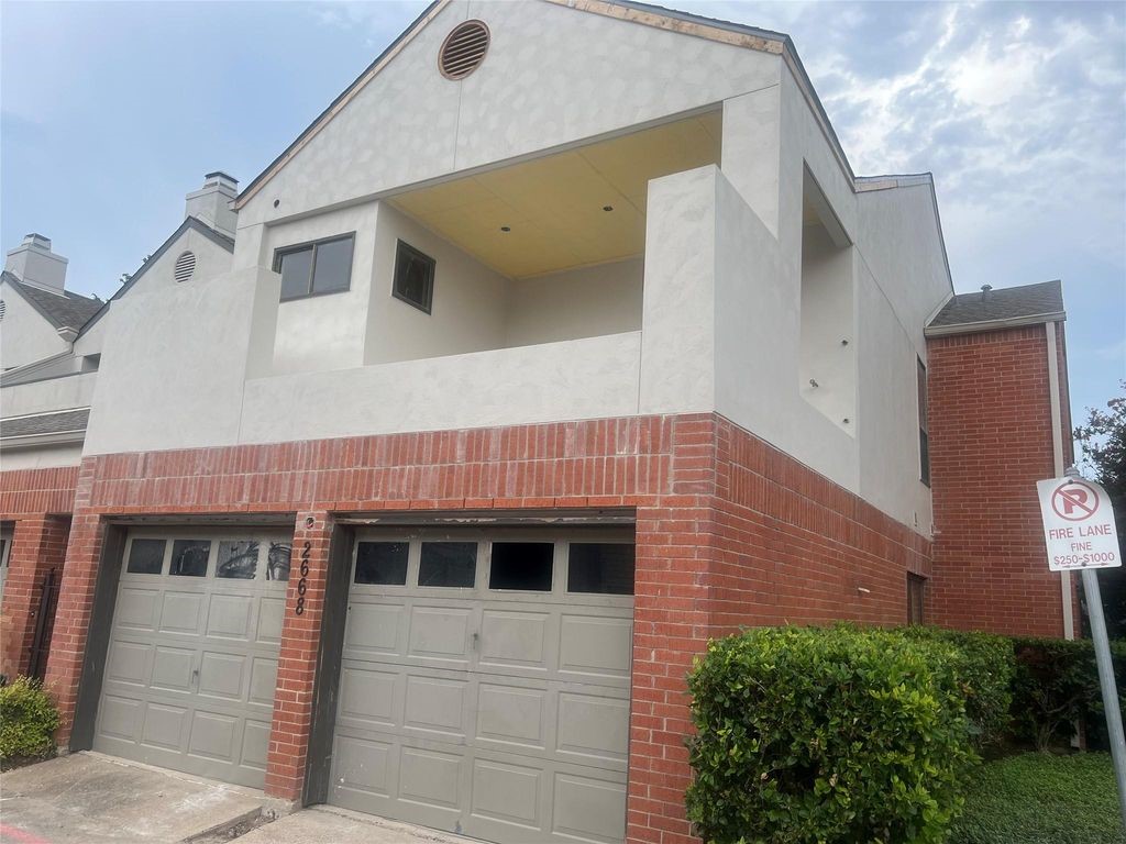 a view of a house with a window and brick walls
