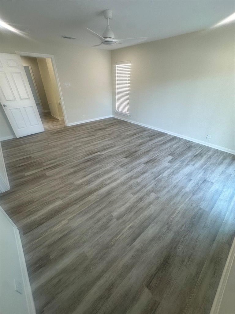 2668 Bering Drive, Unit 2668 Houston, TX 77057 - Photo 37 of 47 a view of an empty room with wooden floor and a window