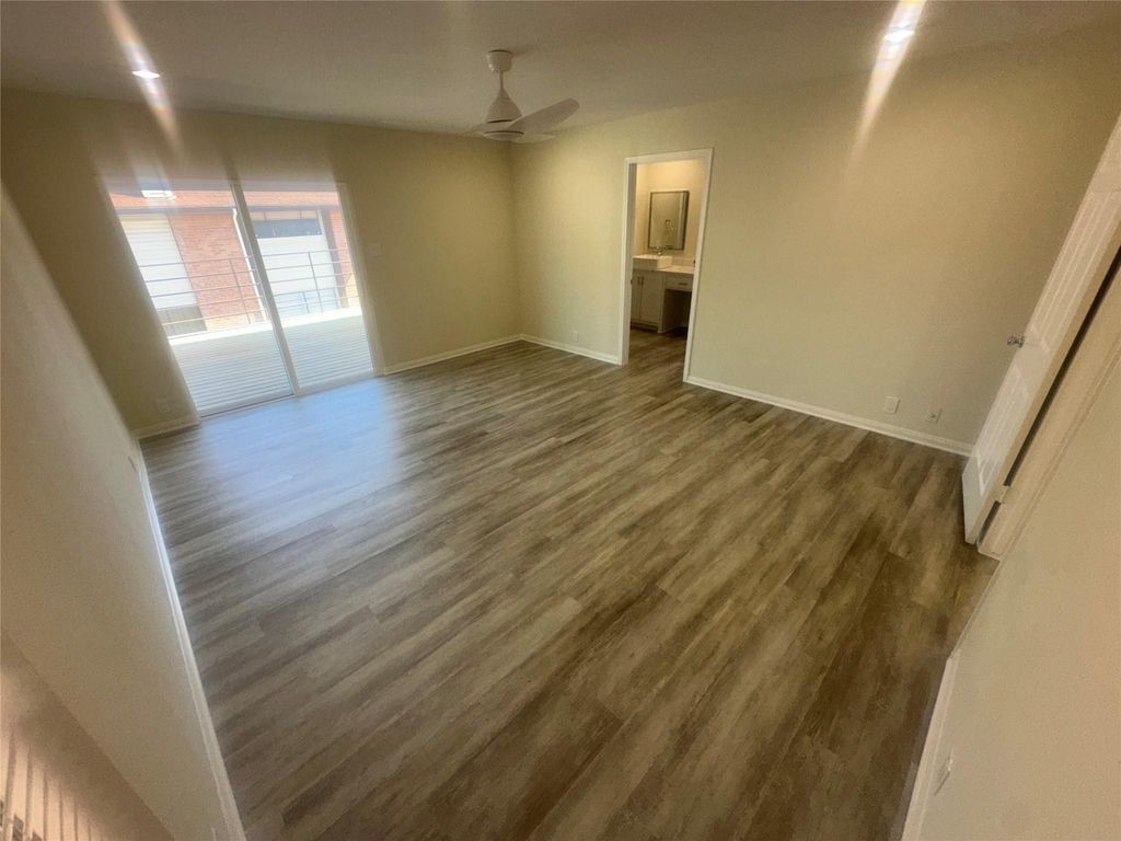 2668 Bering Drive, Unit 2668 Houston, TX 77057 - Photo 39 of 47 a view of empty room with wooden floor and fan