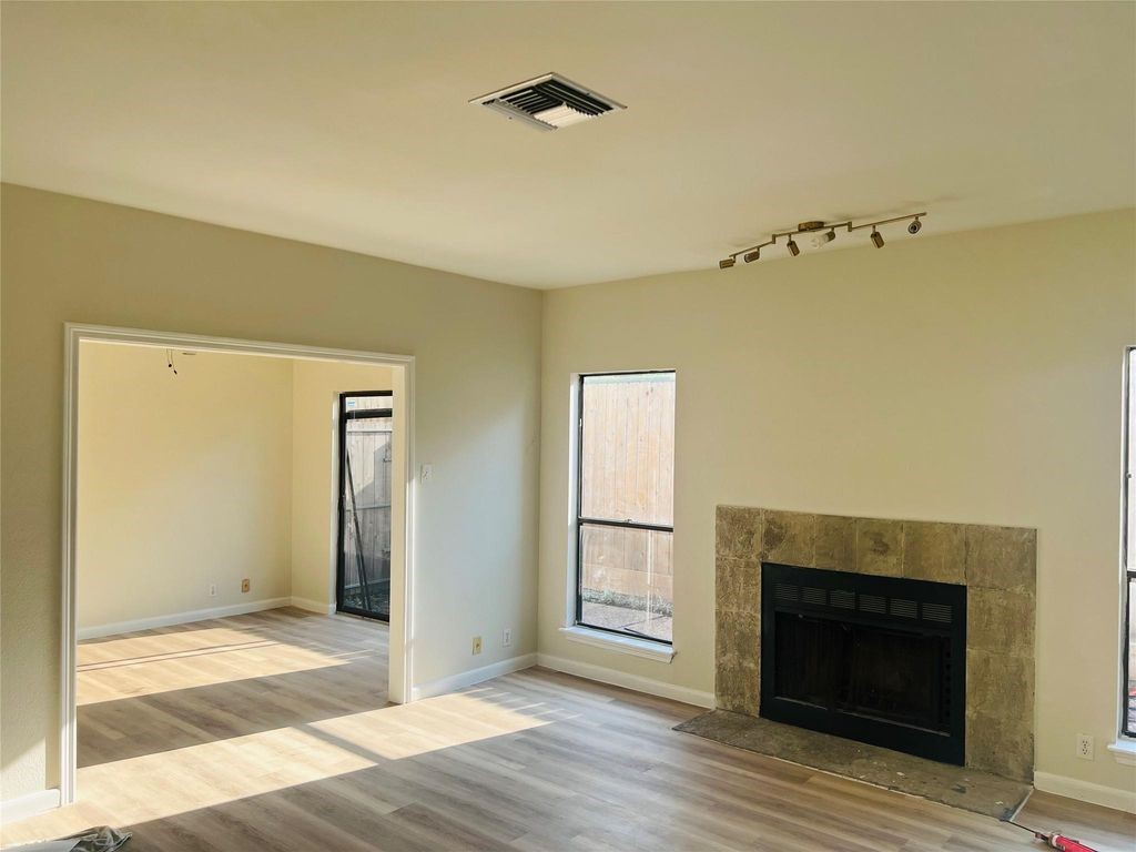 2668 Bering Drive, Unit 2668 Houston, TX 77057 - Photo 4 of 47 a view of a livingroom with a fireplace and wooden floor