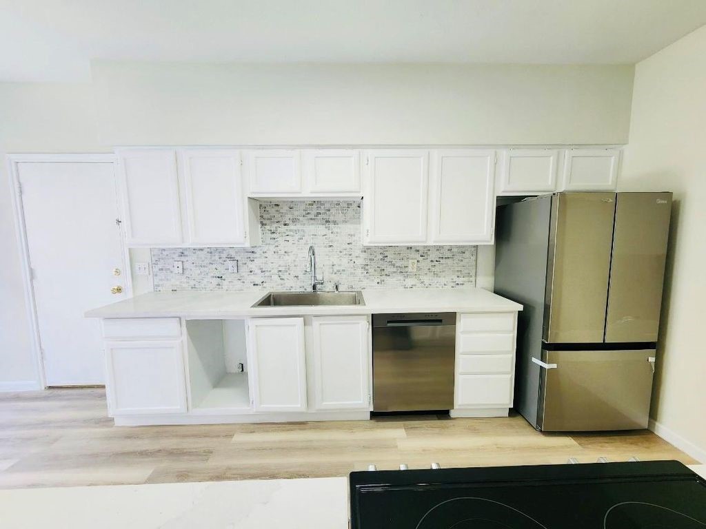 2668 Bering Drive, Unit 2668 Houston, TX 77057 - Photo 8 of 47 a kitchen with a sink and refrigerator