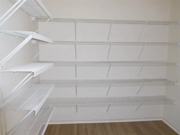 a view of a closet with racks on the wall