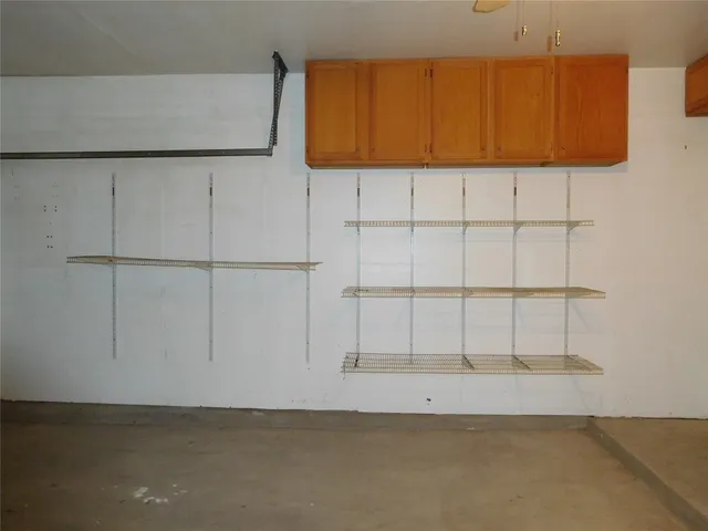 a view of a utility room with window and cabinet