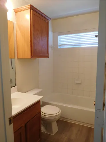 a bathroom with a toilet a sink and bathtub