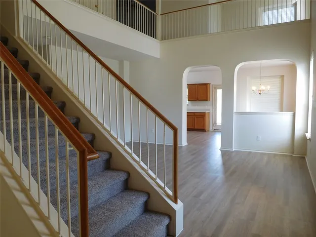 a view of entryway and hall with wooden floor